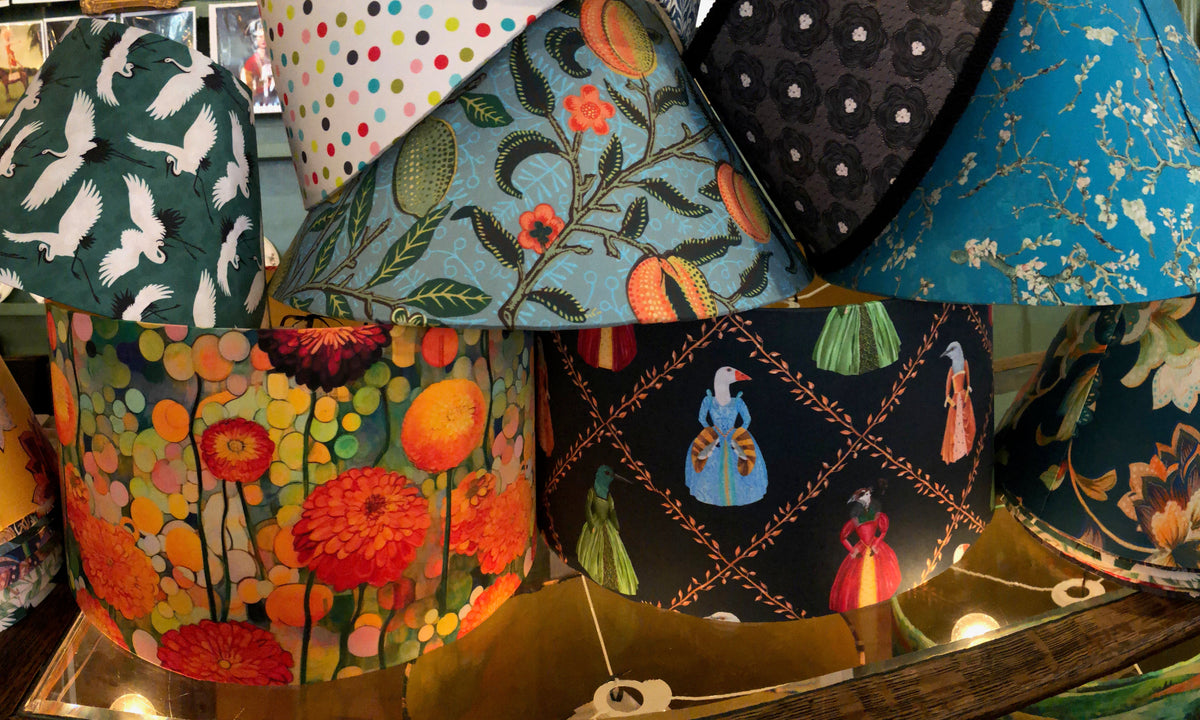 A selection of patterned lampshades piled up together. 