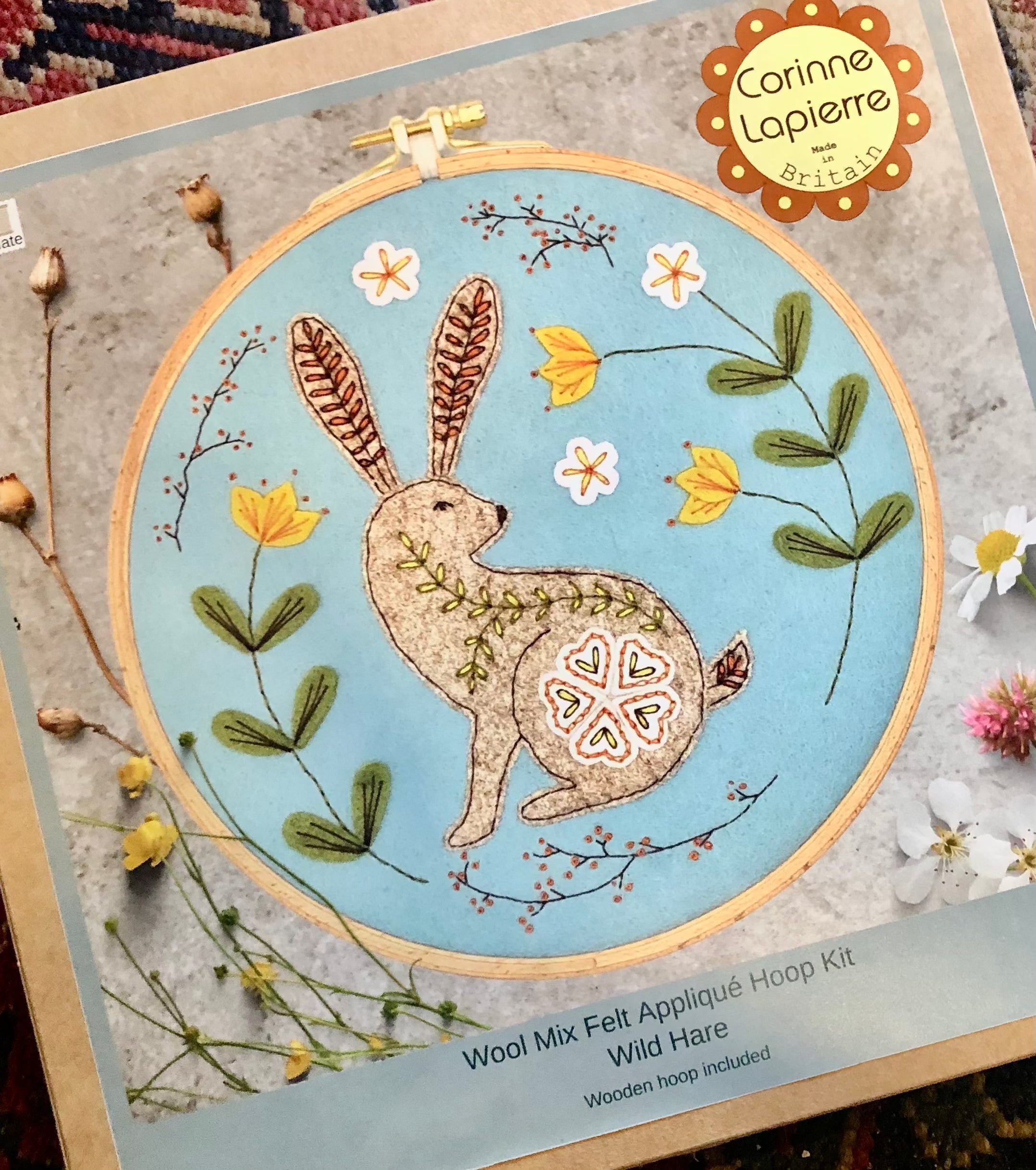 Wool mix felt applique hoop kit with image of a hare on a blue background. 