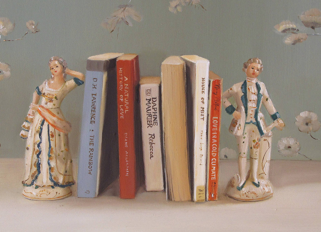 Books between bookends which are an 18th century couple. 